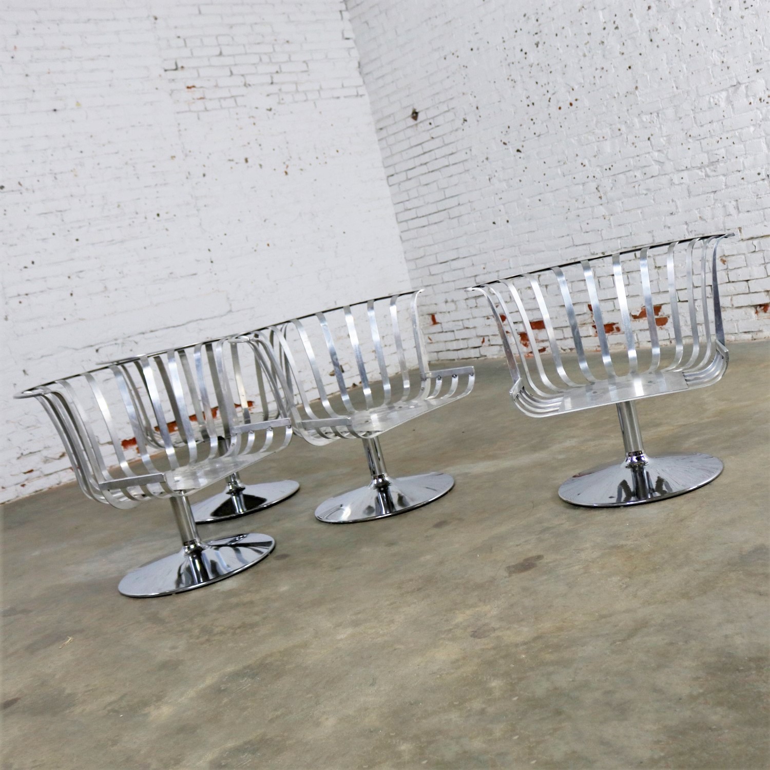Polished Aluminum Tulip Shaped Swivel Lounge Chairs by Russell Woodard Set of Four
