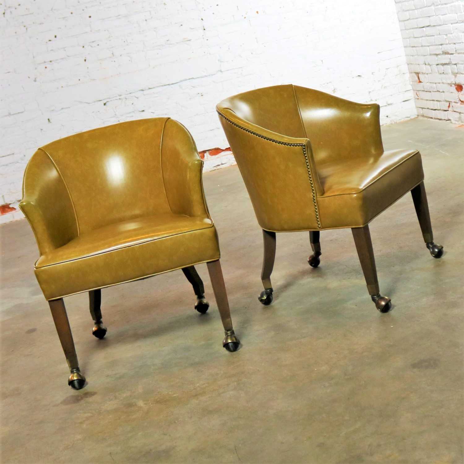 Pair of Mid Century Naugahyde Olive Green Rolling Barrel Chairs with Nail Head Accent