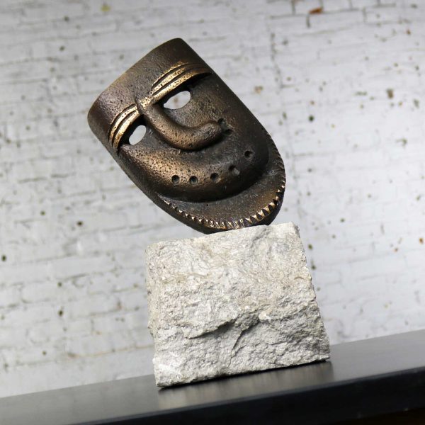 Cast Bronze African Mask Sculpture with Crooked Nose Mounted on Limestone Stand