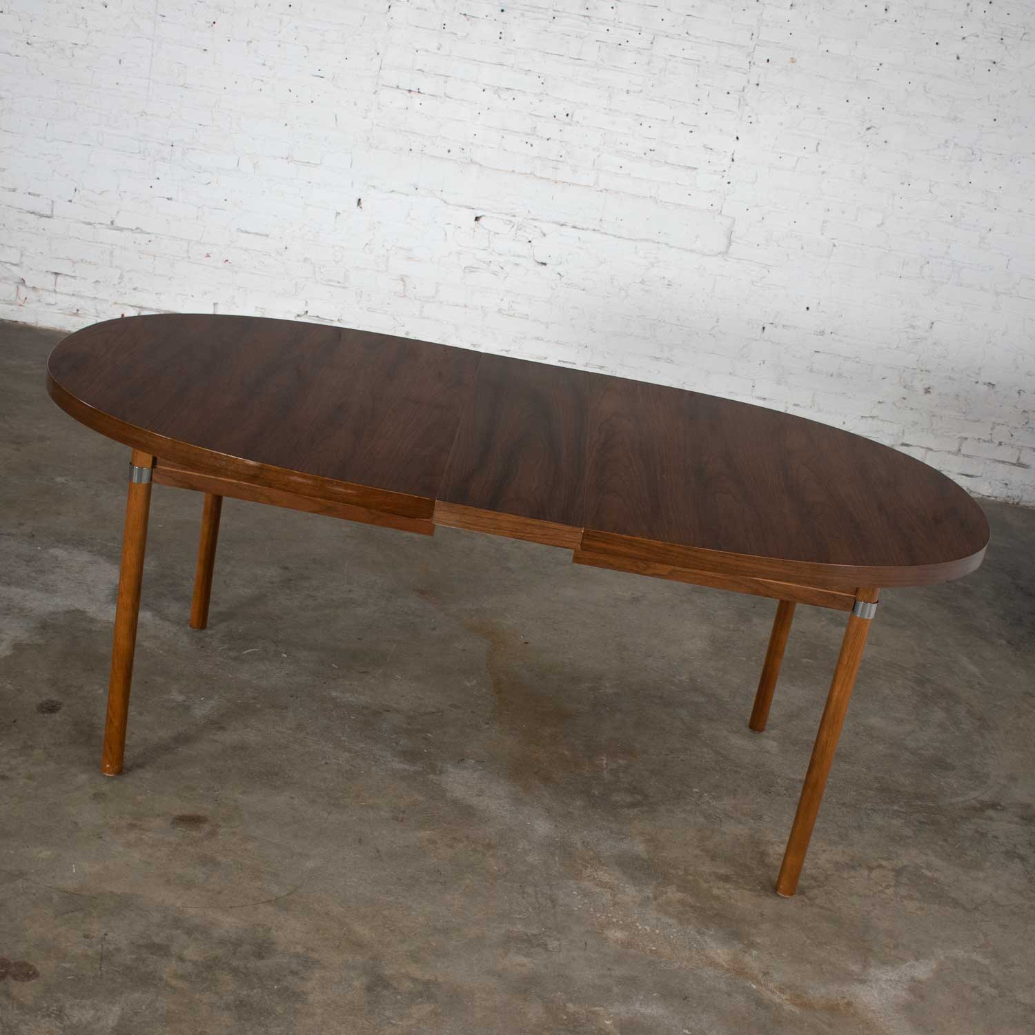 MCM Oval Walnut Toned Expanding Dining Table with Chrome Accents and Wood Grain Laminate Top