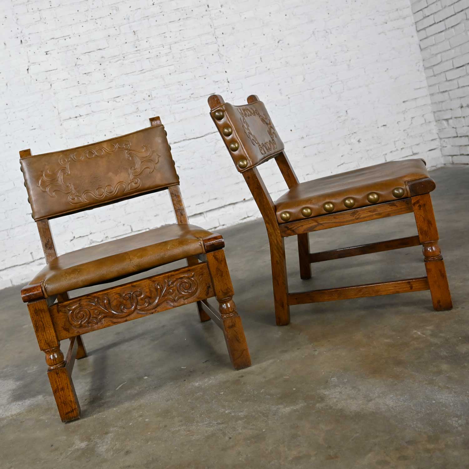 Vintage Spanish Revival Oak Pair of Chairs with Tooled Cognac Faux Leather Seat Backs Style Artes De Mexico