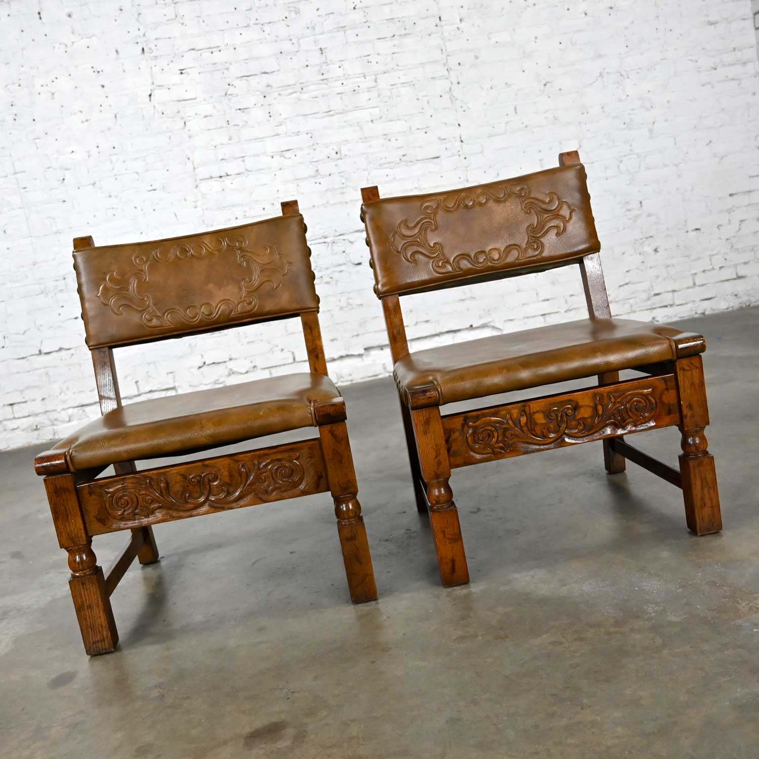 Vintage Spanish Revival Oak Pair of Chairs with Tooled Cognac Faux Leather Seat Backs Style Artes De Mexico