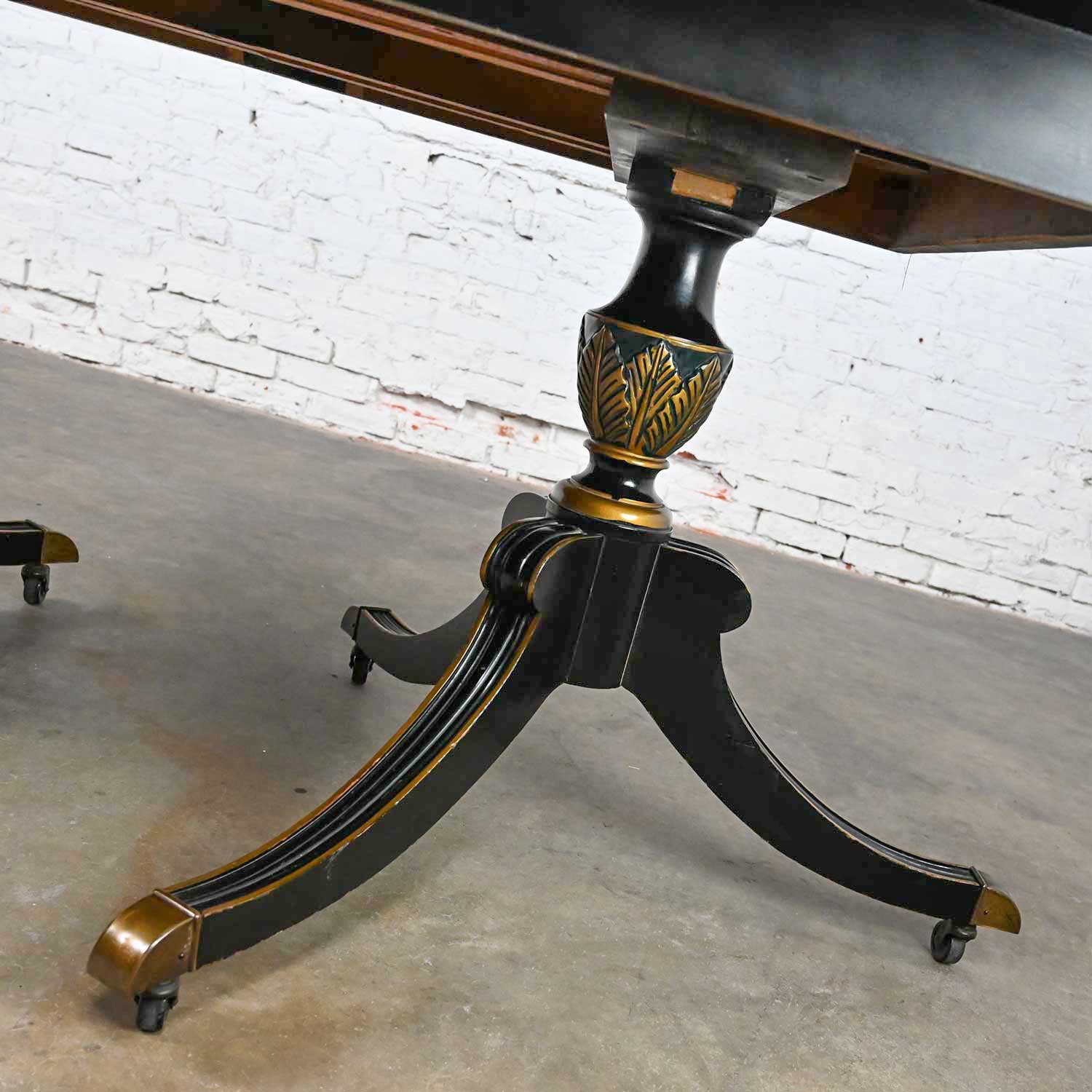 Mid-20th Century Chinoiserie Regency Style Union National Black Painted & Gilt Dining Table Double Tripod Base