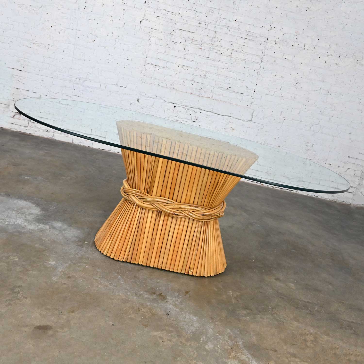 Late 20th Century McGuire Style Racetrack Oval Natural Rattan Sheaf of Wheat Glass Top Dining Table