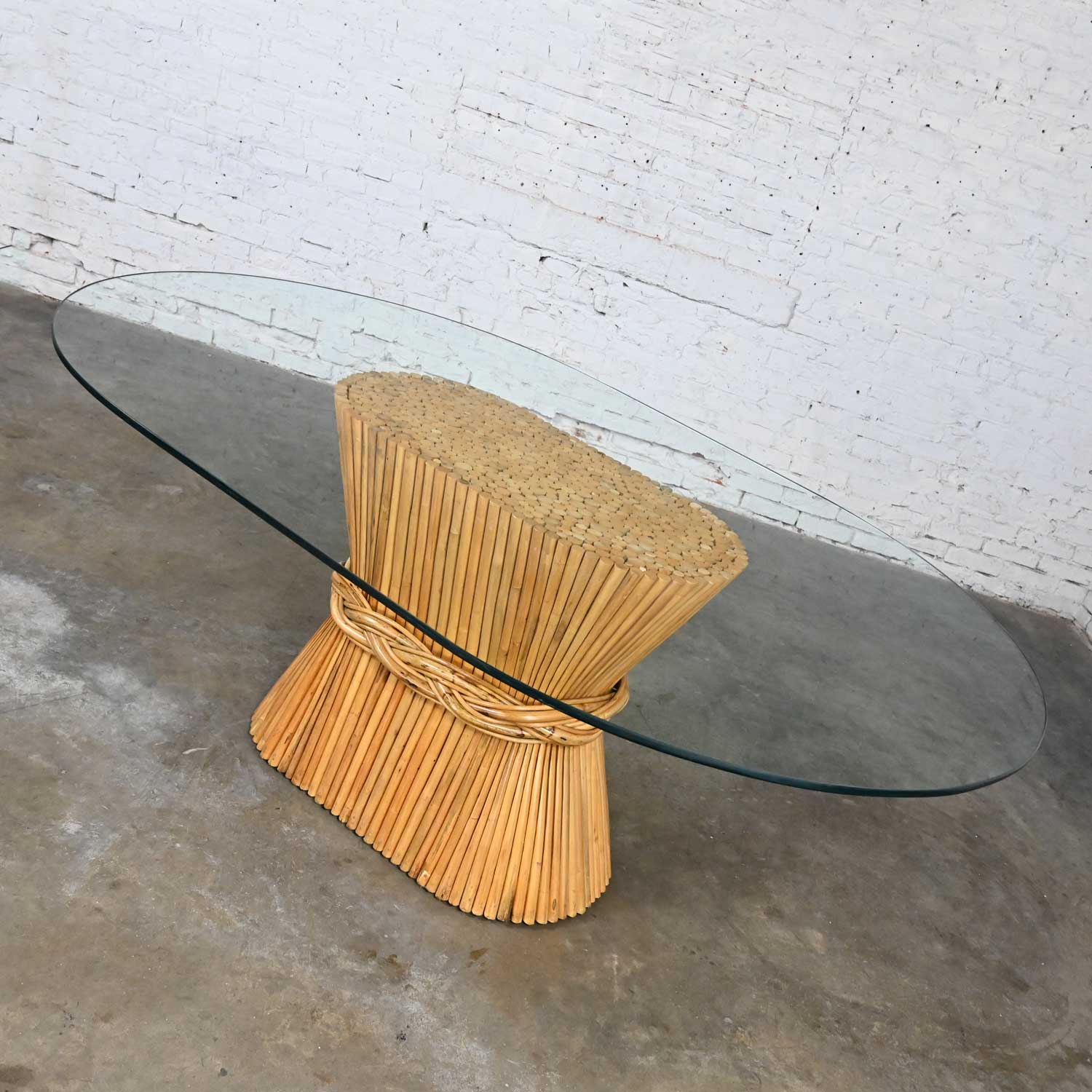 Late 20th Century McGuire Style Racetrack Oval Natural Rattan Sheaf of Wheat Glass Top Dining Table