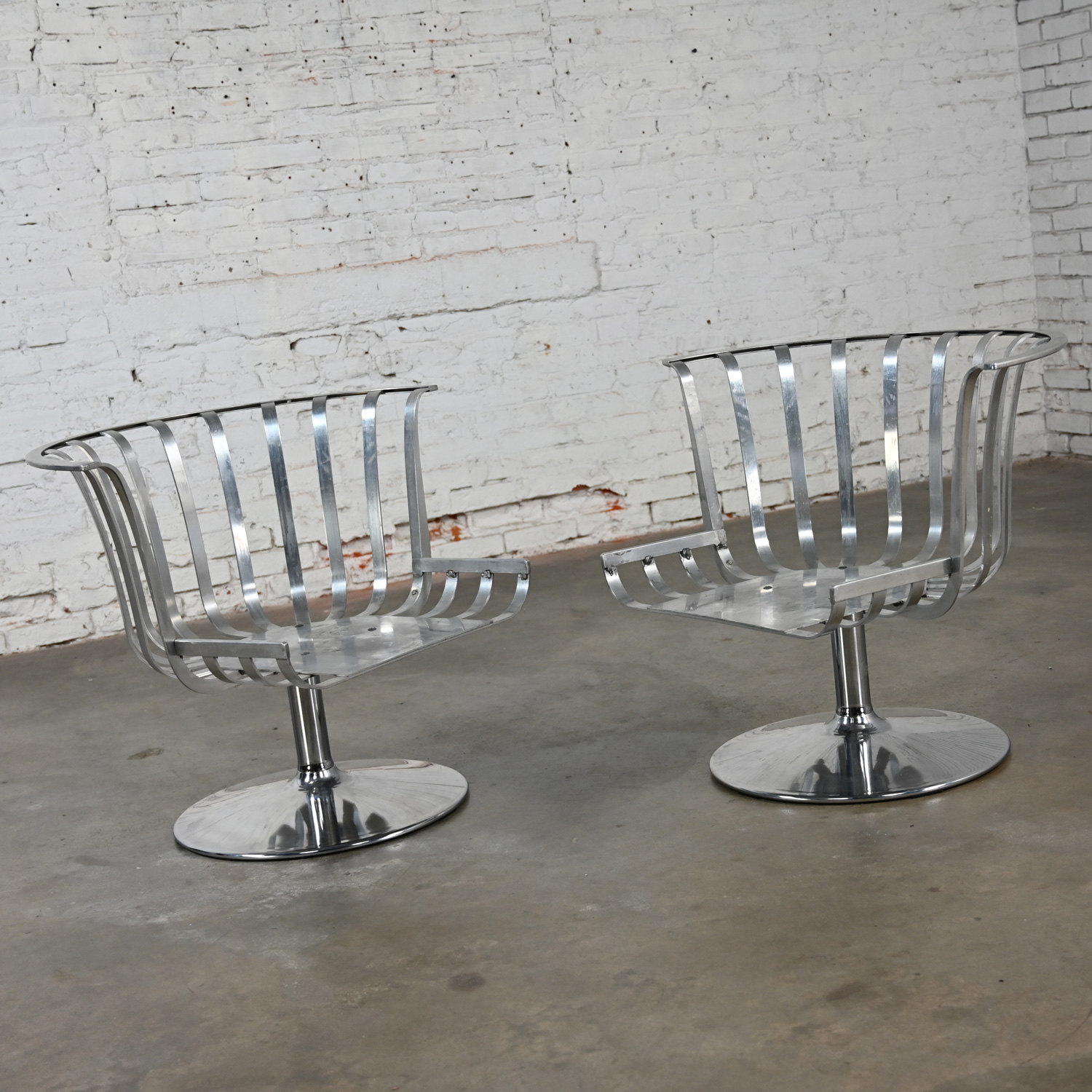 1960’s MCM Polished Aluminum Barrel Swivel Lounge Chairs with Chrome Tulip Base by Russell Woodard a Pair