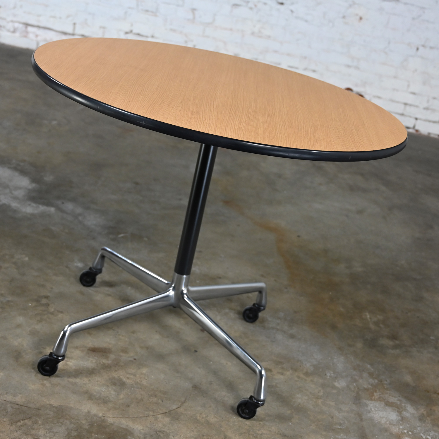 Vintage MCM Eames for Herman Miller Table Aluminum Universal Base with Black Casters & 36” Round Blonde Laminate Top